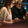 Woman and man use onOffice enterprise on their laptop